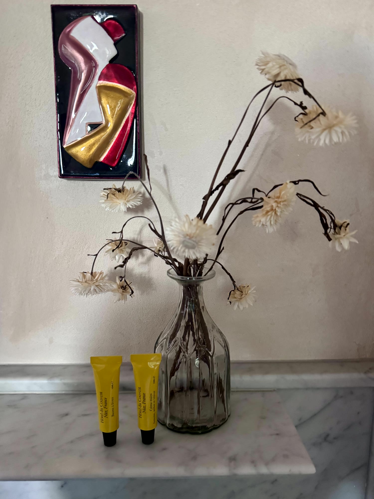 Dried flowers in a glass vase on marble, the room at Hôtel du Couvent