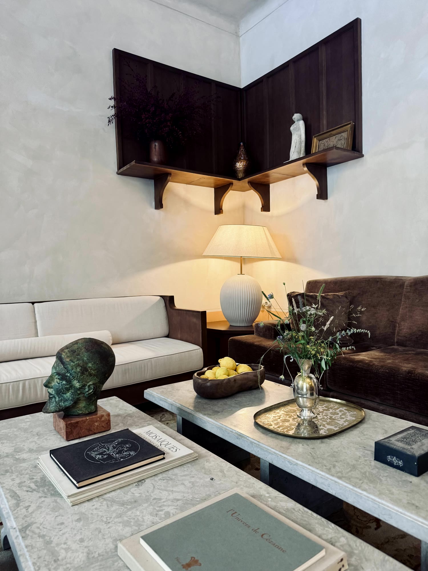 The salon, books on marble, a bronze head, a velvet sofa