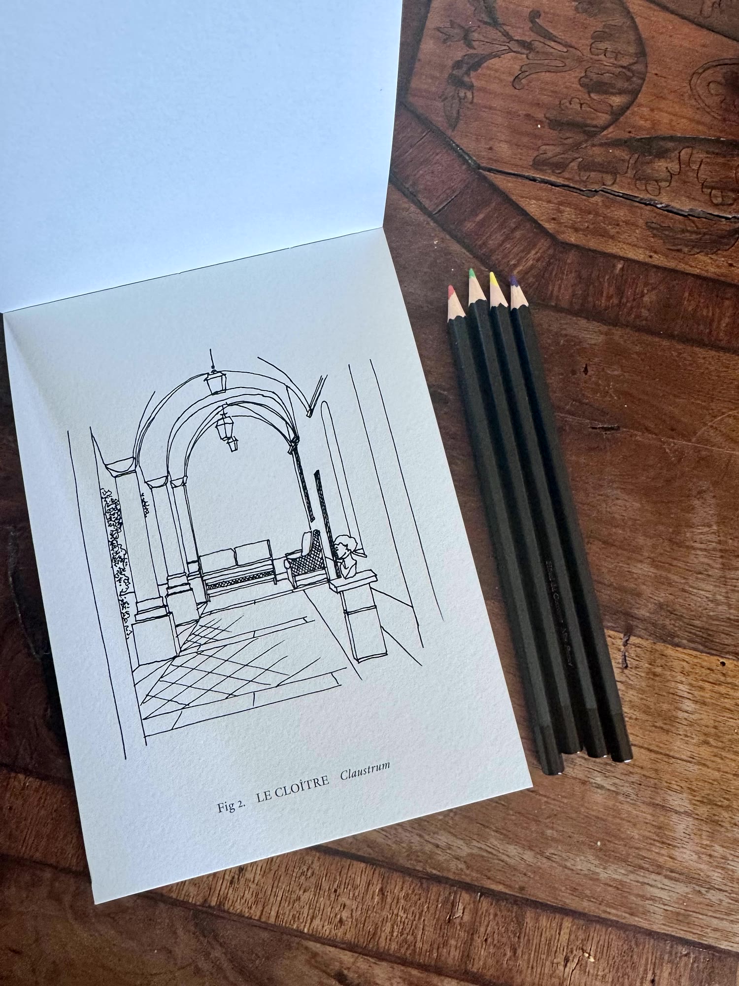 The cloister colouring book and pencils on the desk, Hôtel du Couvent