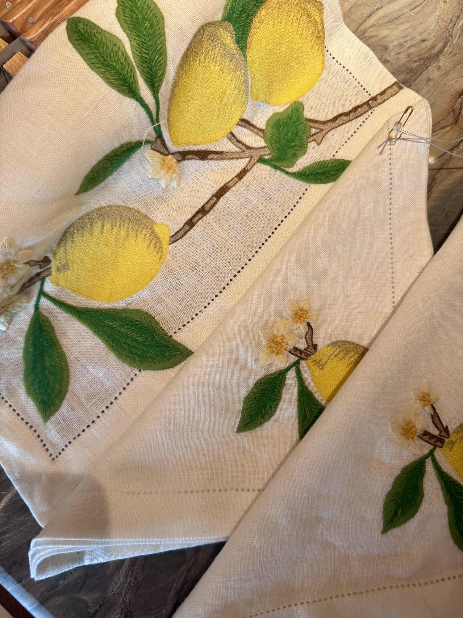 Lemon-embroidered linen napkins on a table in Rome