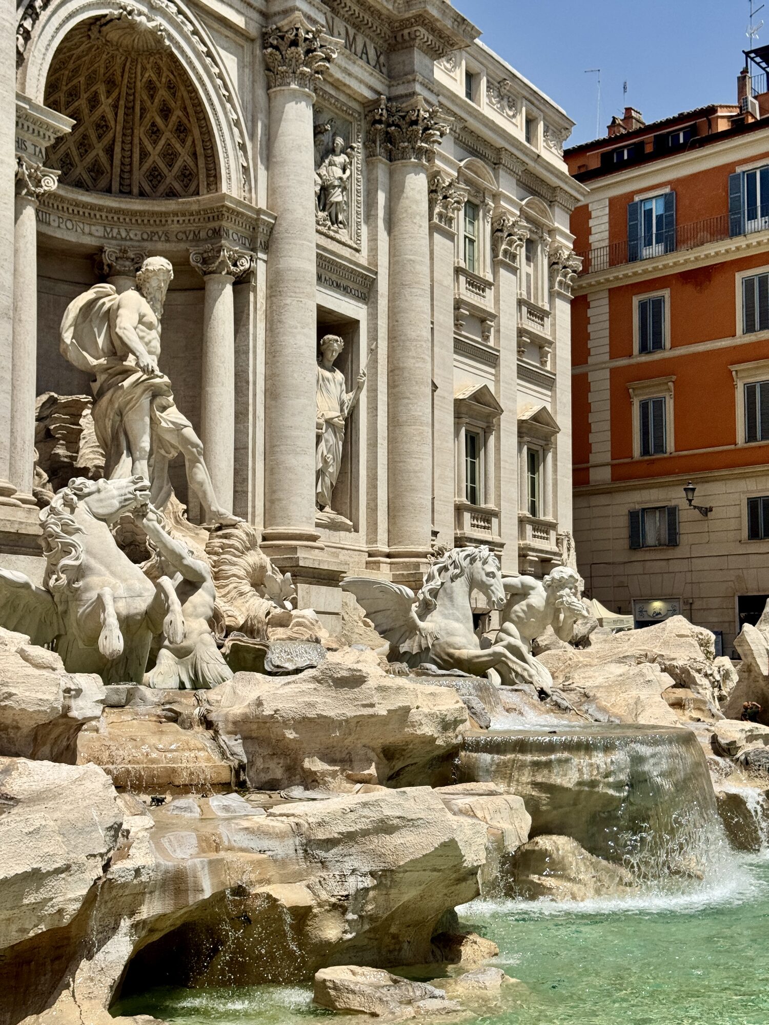 The Trevi Fountain, baroque figures in travertine above turquoise water