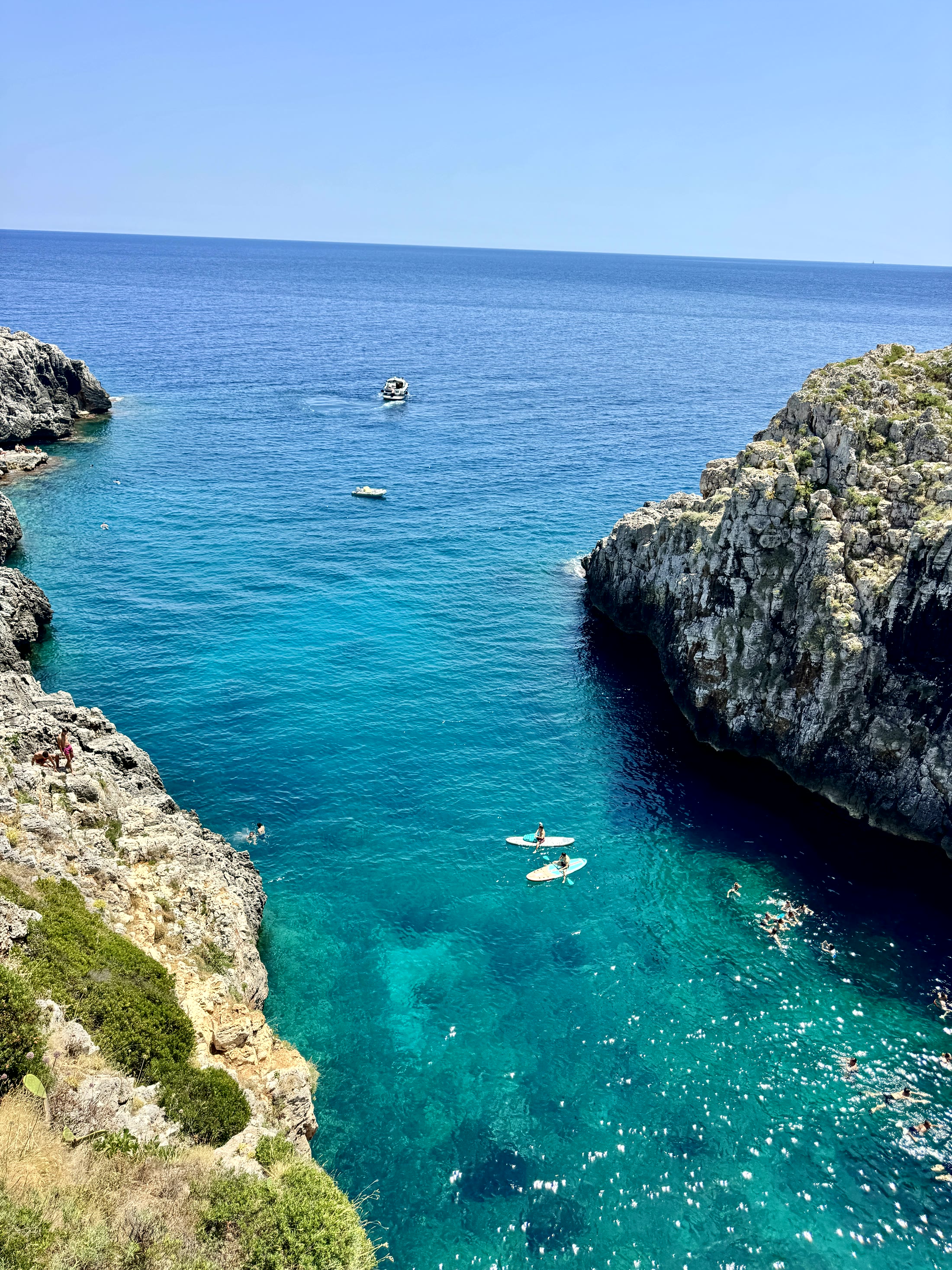 A turquoise inlet between limestone cliffs on the Adriatic coast of the Salento