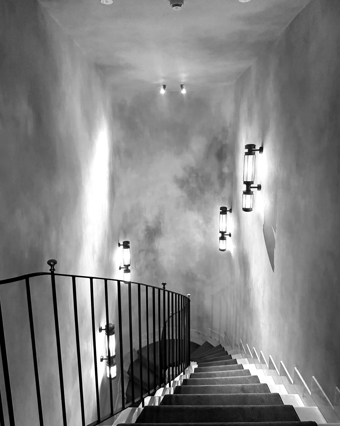 A staircase with wall sconces, Rome