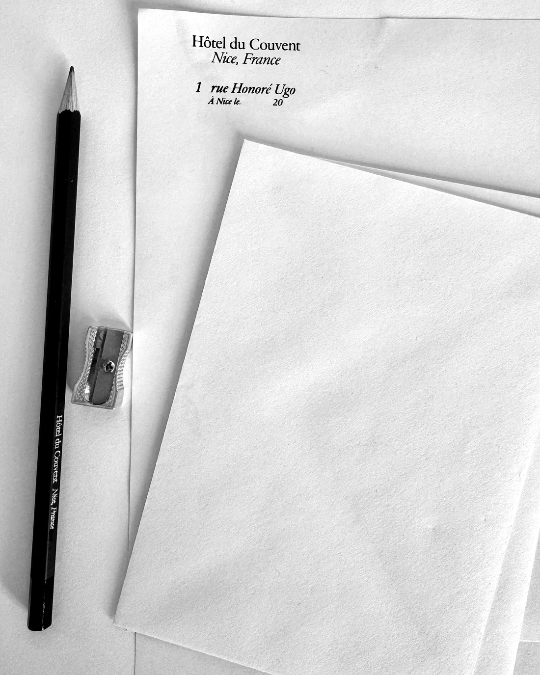 Hotel writing paper, a pencil and a sharpener