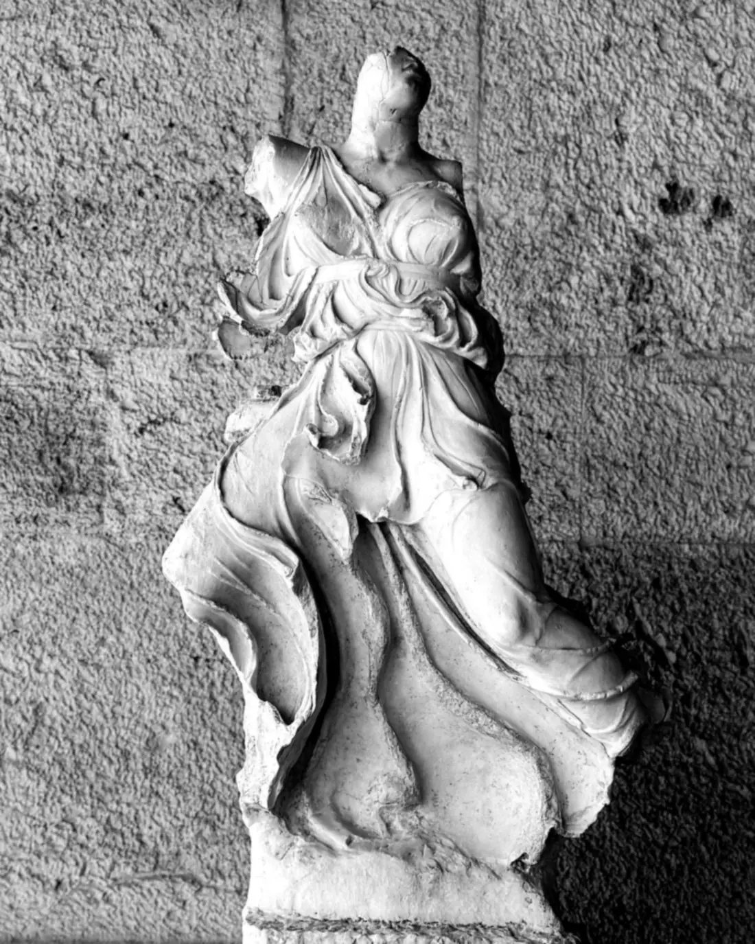 Marble fragment on a stone wall